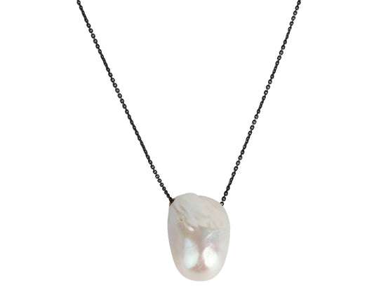 Elegant baroque pearl pendant necklace with black chain, featuring a lustrous white freshwater pearl center.