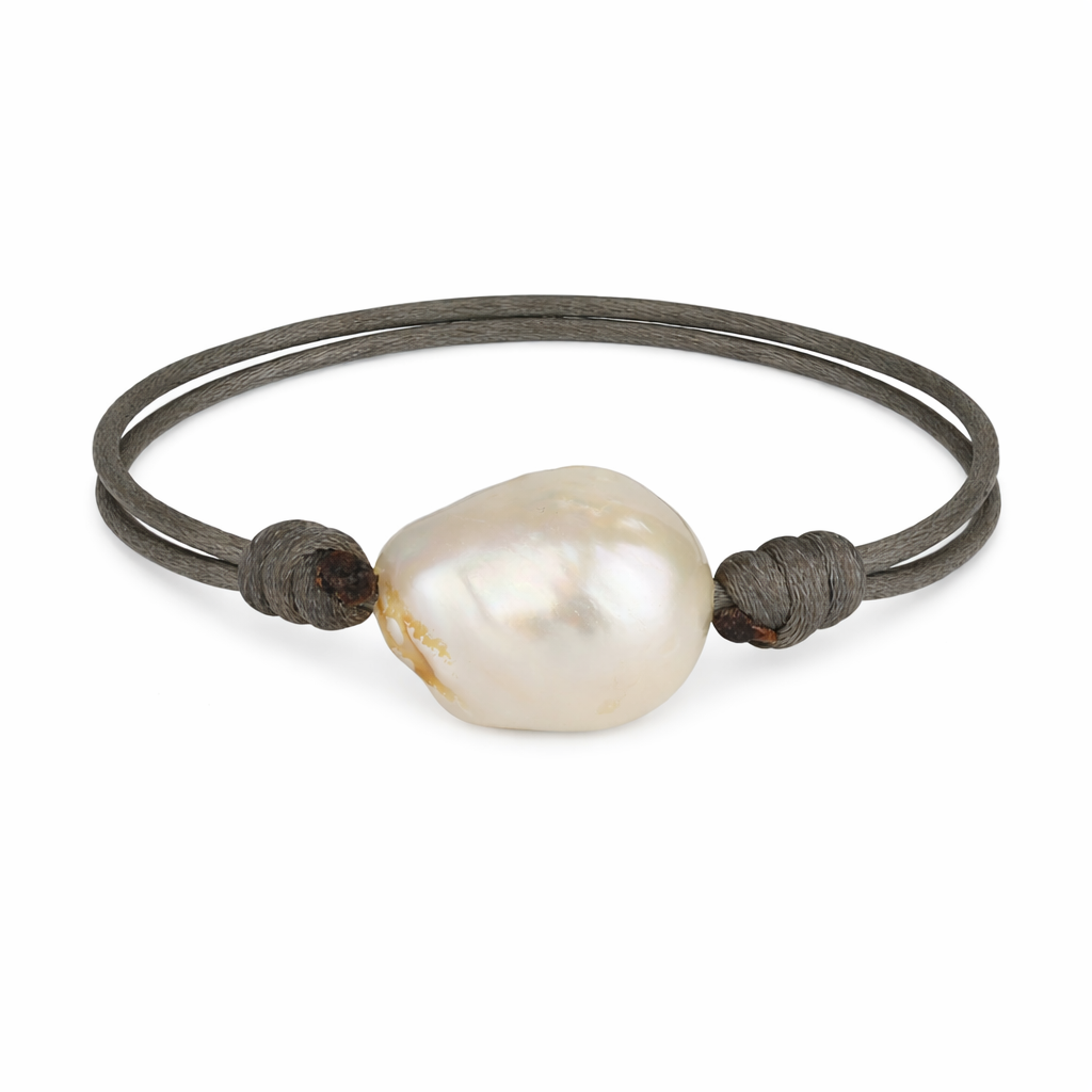 Pearl bracelet with dark cord on a white background