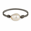 Pearl bracelet with dark cord on a white background