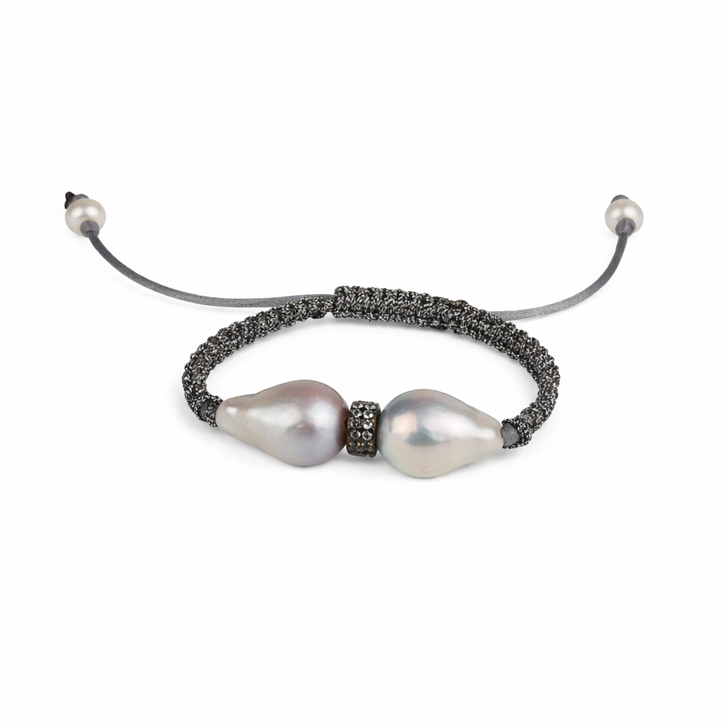 Pearl bracelet with black cord on a white background