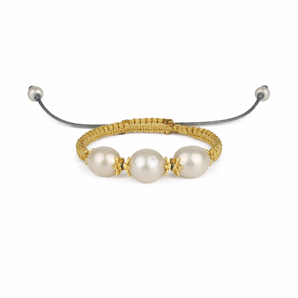 Bracelet with pearls and gold accents on a white background