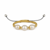 Bracelet with pearls and gold accents on a white background