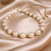 Ella JLL Pearl necklace on fabric – round pearls and gold flower findings on satin thread