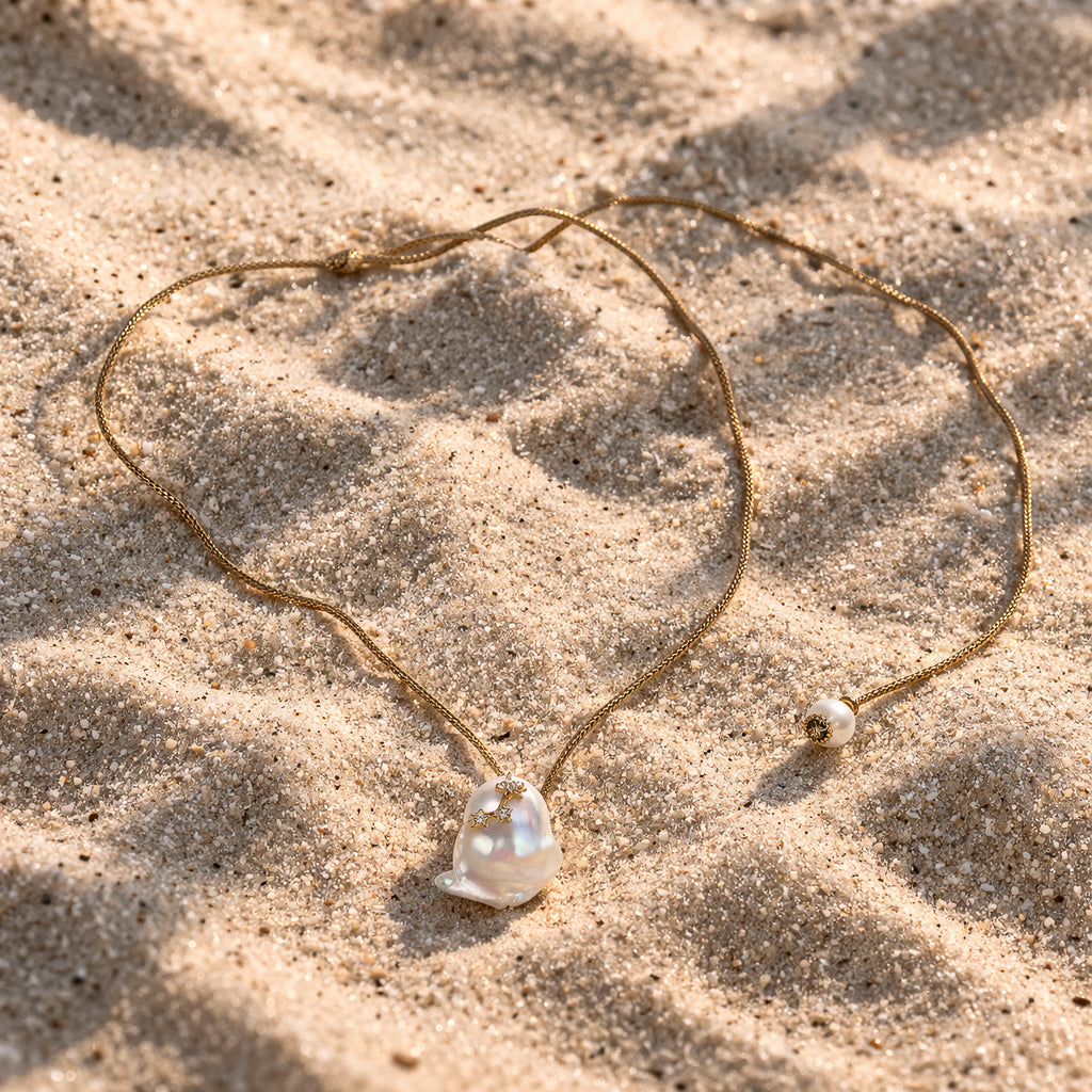 Mila JLL Pearl necklace on sand – baroque pearl and topaz stars on golden satin thread