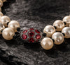 Close up of theElegant baroque pearls necklace Adele with garnets and diamonds ball centerpiece, featuring a vibrant and delicate design-JLLPearl