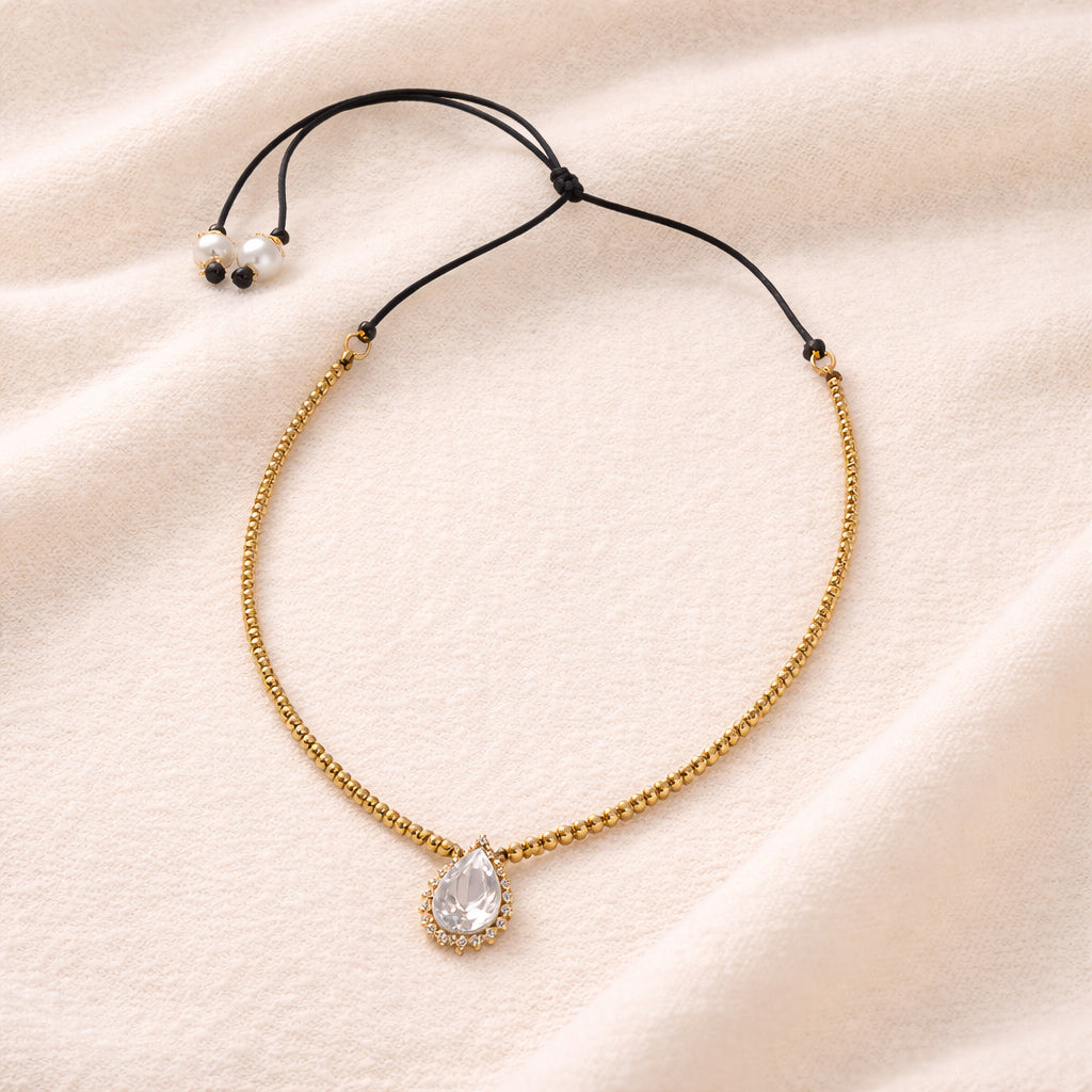 Romy JLL Pearl necklace on fabric – gold hematites, white topaz and yellow sapphire on satin