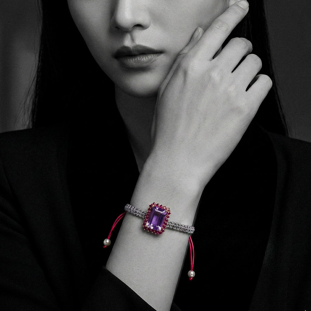 Multicolor woven bracelet with emerald-cut light-purple amethyst and ruby-red halo on adjustable cord