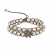 A three-round freshwater pearl bracelet with a silver gray thread and a silver star adorned with champagne diamonds.