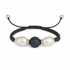 A bracelet featuring two round freshwater pearls, two sparkling diamond bicones, and a ball of blue sapphires set in silver, with black macrame thread and pearl beads.