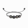 A light gray silver macramé bracelet with three Tahitian pearls and multicolored semiprecious stones, featuring a ball of multicolored stones and a leather loop.