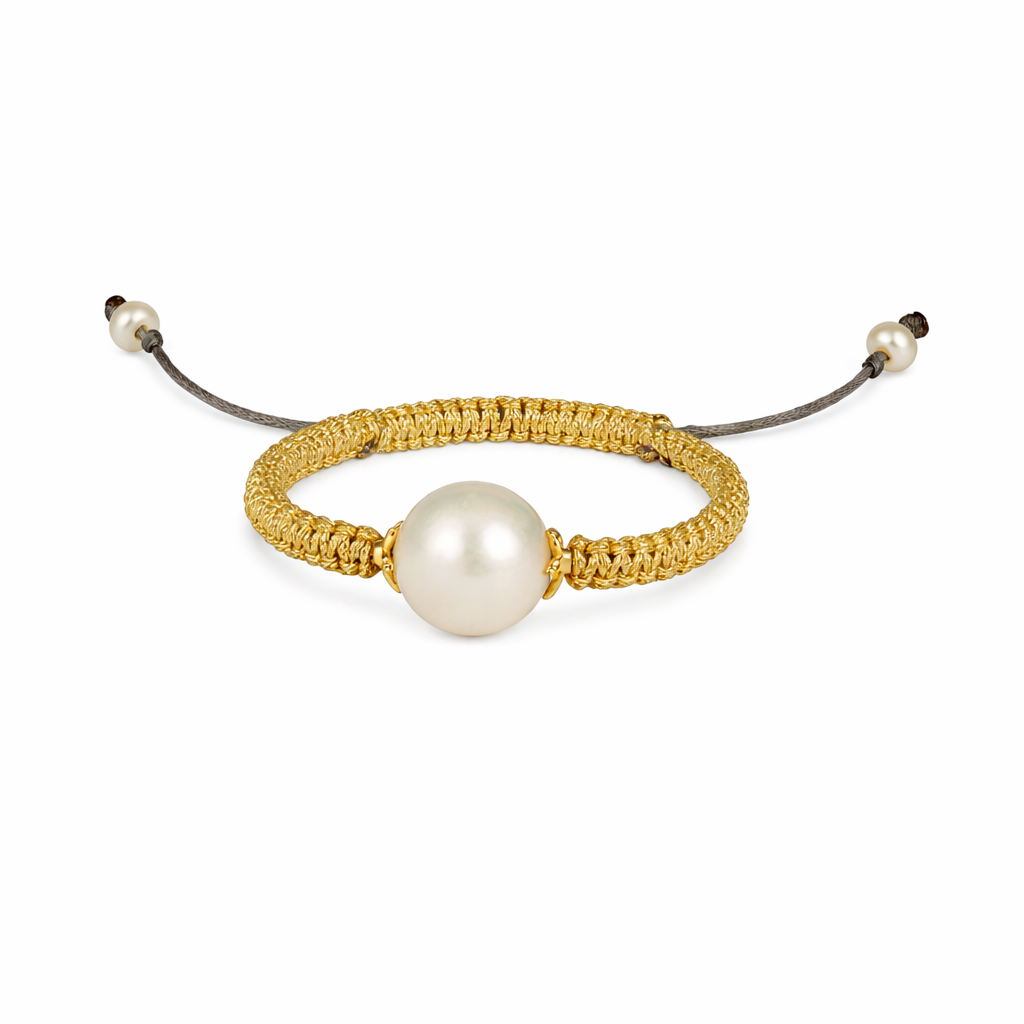 Gold bracelet with a pearl on a white background