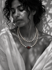 Woman wearing Adele long pearl necklace doubled at the throat with red gemstone centerpiece — JLL Pearl