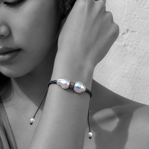 Black and white portrait of a double baroque pearl bracelet on dark braided cord — JLL Pearl