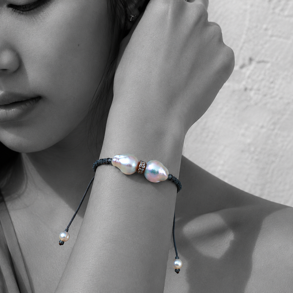 Black and white portrait of a double baroque pearl bracelet on dark braided cord — JLL Pearl