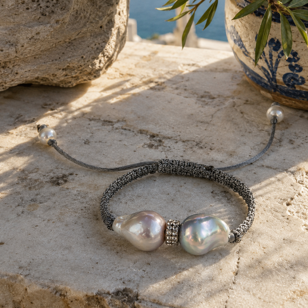 Butterfly macramé bracelet baroque grey pearls on Greek marble — sea view, Mediterranean terrace, natural light