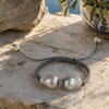 Butterfly macramé bracelet baroque grey pearls on Greek marble — sea view, Mediterranean terrace, natural light