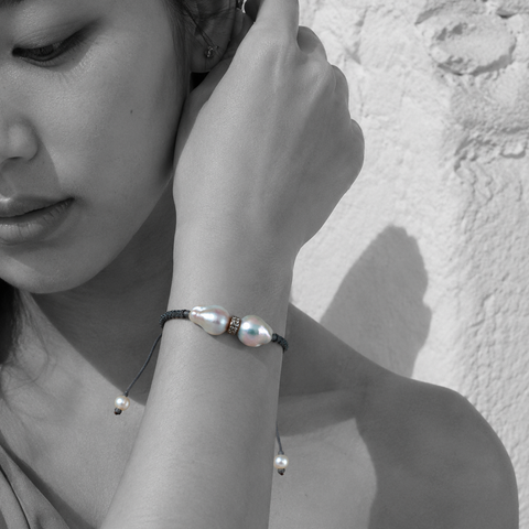 Butterfly macramé bracelet with baroque grey pearls — black and white portrait, Asian woman, Greek stone wall