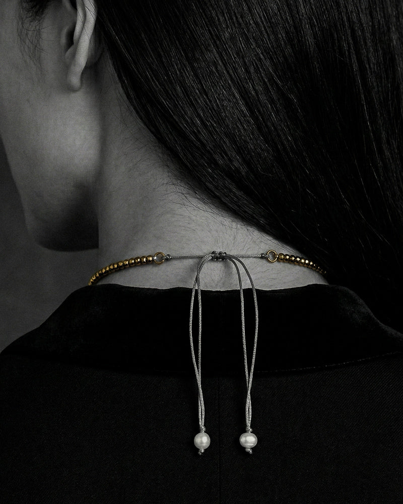 Flowerdream freshwater pearl hematite topaz necklace worn at the nape, lasso cord with two round pearl stoppers visible, B&W with necklace in natural colour, handmade by JLL Pearl