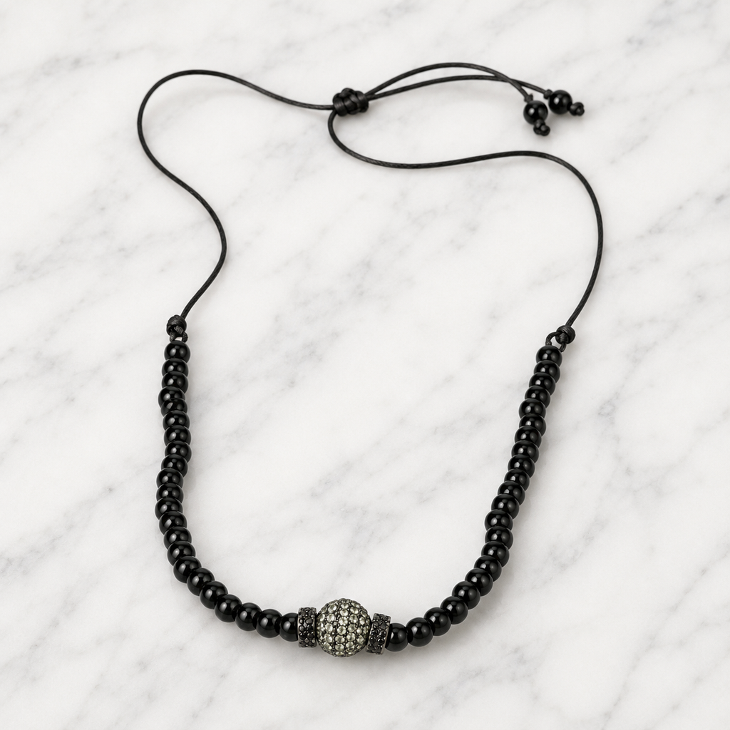 Hydra black onyx beaded necklace with grey pavé centerpiece, flatlay on white marble — JLL Pearl