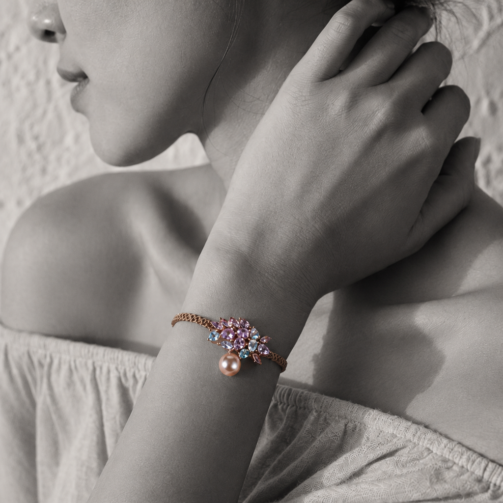 Black and white portrait of a rose gold gemstone cluster bracelet with pink pearl on the wrist — JLL Pearl