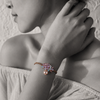 Black and white portrait of a rose gold gemstone cluster bracelet with pink pearl on the wrist — JLL Pearl
