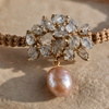 Karla bracelet by JLL Pearl — macro close-up on raw grey crystal chip cluster in gold setting, with hanging baroque blush-pink freshwater pearl on a fine gold link