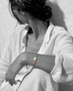 Woman wearing Kastos bracelet with baroque pearl and blue-violet sapphire gold centerpiece — JLL Pearl