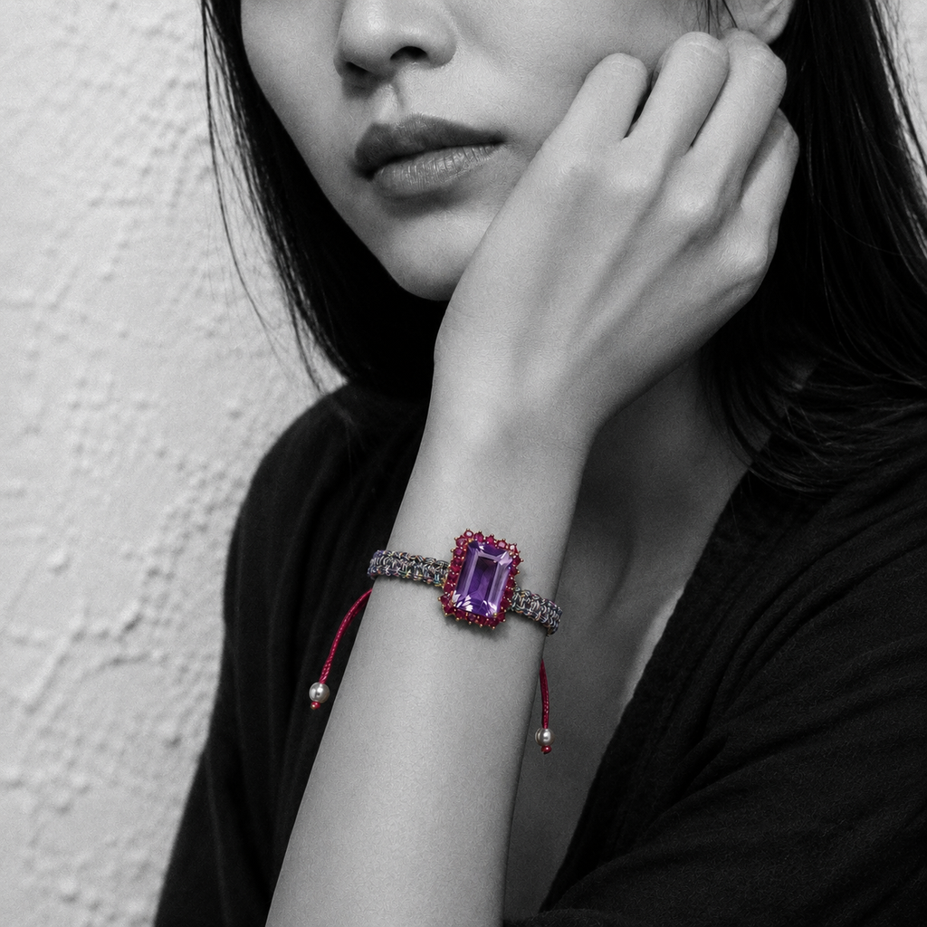 Kos amethyst topaz woven bracelet — black and white portrait, selective colour on pale lavender amethyst and pink topaz halo, Greek plastered wall — JLL Pearl