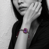 Kos amethyst topaz woven bracelet — black and white portrait, selective colour on pale lavender amethyst and pink topaz halo, Greek plastered wall — JLL Pearl