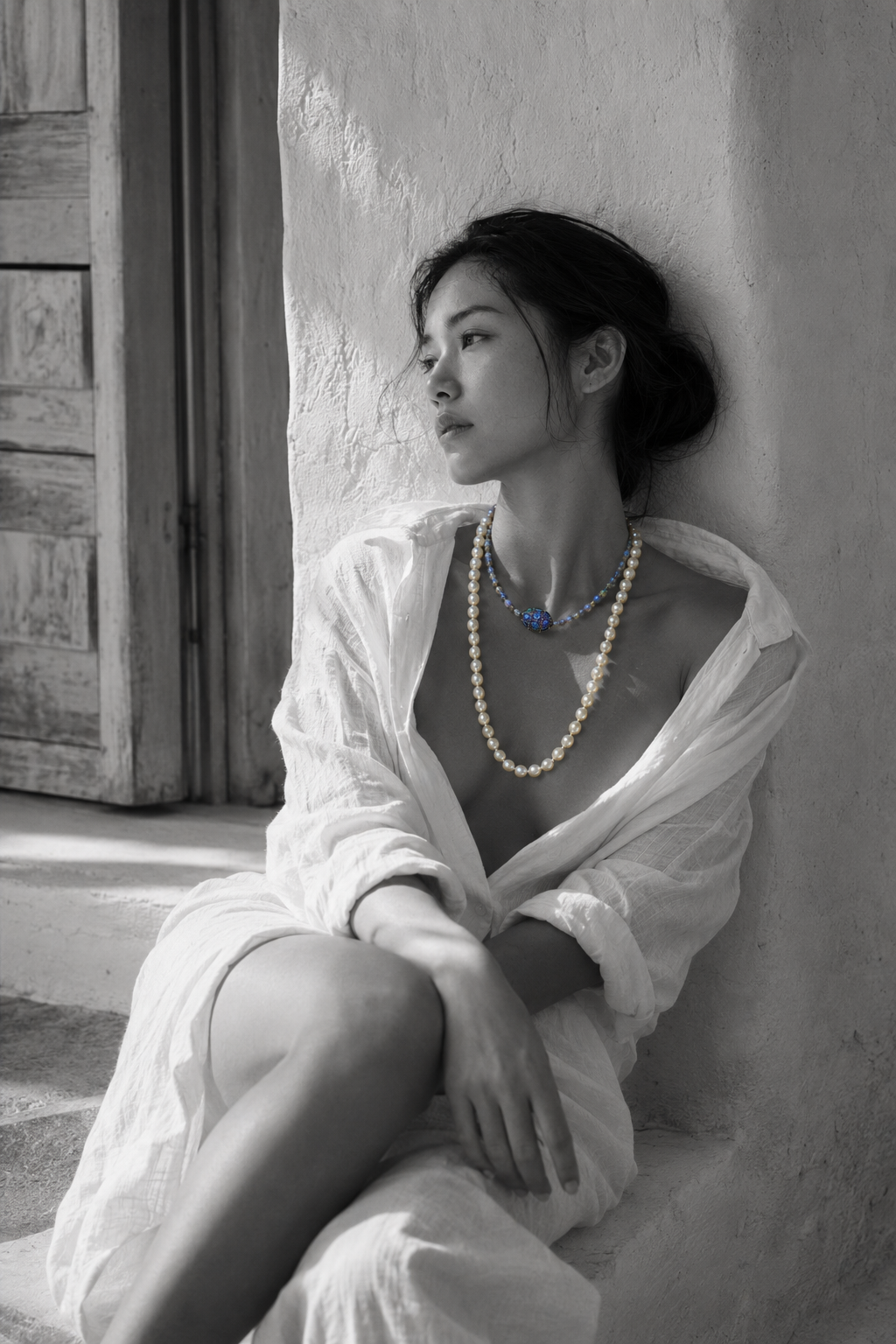 Lola freshwater pearl labradorite necklace worn by an Asian model seated near a Greek window, both strands on bare décolleté, oxidized silver connector in colour against black and white, handmade by JLL Pearl