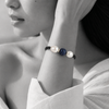 Black and white portrait of a pavé sapphire bead bracelet flanked by two pearls on black cord — JLL Pearl