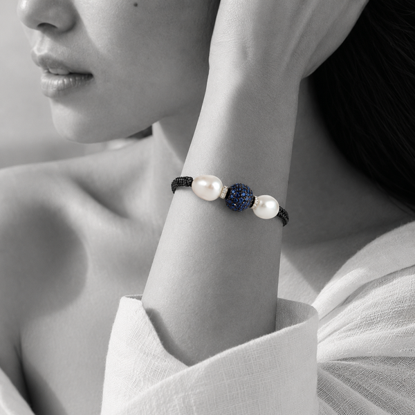 Black and white portrait of a pavé sapphire bead bracelet flanked by two pearls on black cord — JLL Pearl