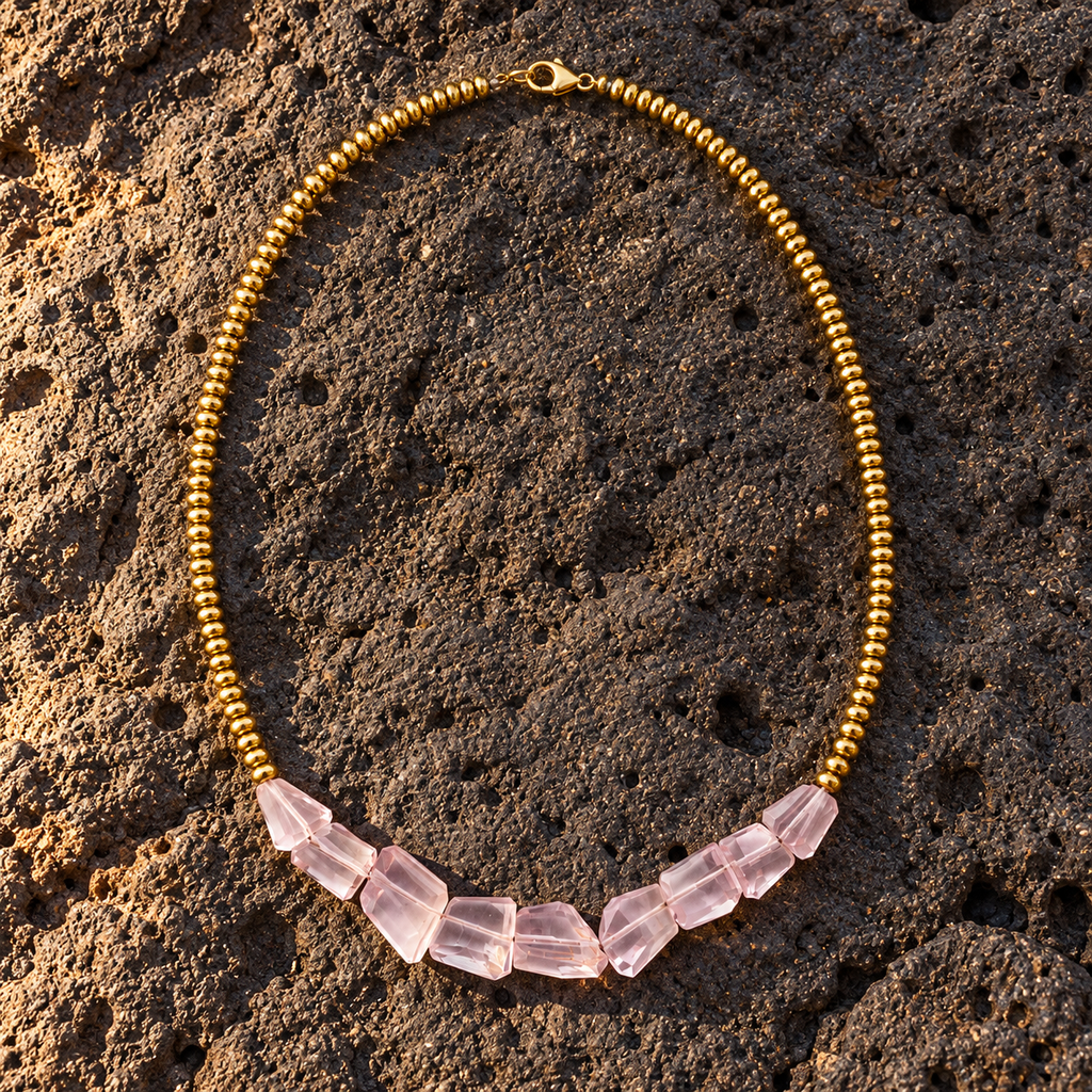 Mani rose amethyst pyrite necklace flatlay on dark volcanic rock, five faceted rose amethyst chunks graduating in size, gold-plated ball beads, lobster clasp, handmade in Greece by JLL Pearl