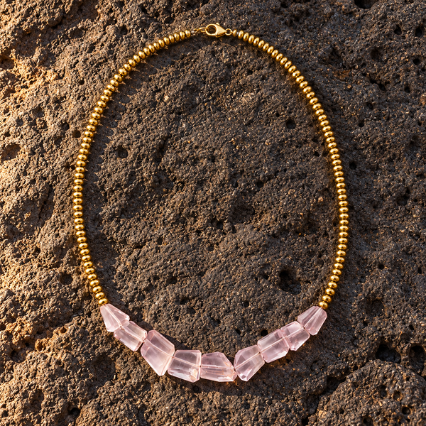 Mani rose amethyst pyrite necklace flatlay on dark volcanic rock, five faceted rose amethyst chunks graduating in size, gold-plated ball beads, lobster clasp, handmade in Greece by JLL Pearl