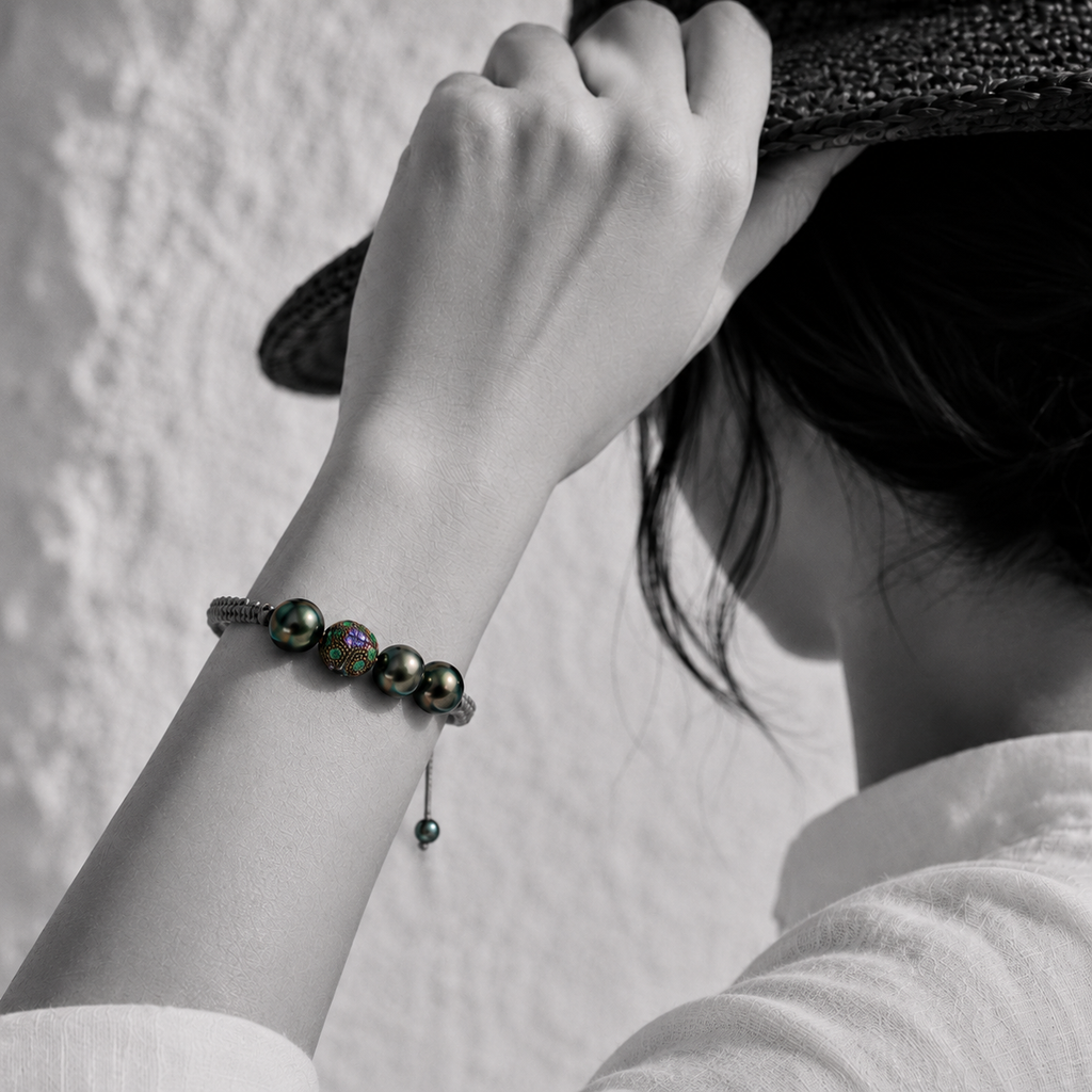 Black and white portrait of a Tahitian pearl bracelet with an ornate centerpiece bead — JLL Pearl