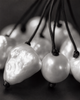Close-up of Peipei baroque pearl cluster necklace, large baroque freshwater pearls showing varied shapes and iridescent surfaces, individual grey satin cord strands, black and white macro photography, JLL Pearl