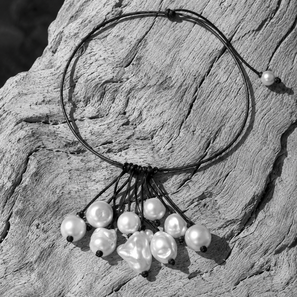 Peipei baroque pearl cluster necklace arranged on sun-bleached driftwood, multiple baroque freshwater pearls hanging from a central grey satin knot, black and white flat lay, handmade by JLL Pearl