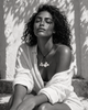 Peipei baroque pearl cluster necklace worn against a whitewashed Mediterranean wall, dappled leaf shadows, woman with eyes closed in white linen shirt, black and white editorial portrait, handmade by JLL Pearl