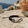 Stella bracelet on Greek marble — two-tone macramé cord, white baroque pearl and champagne diamond star