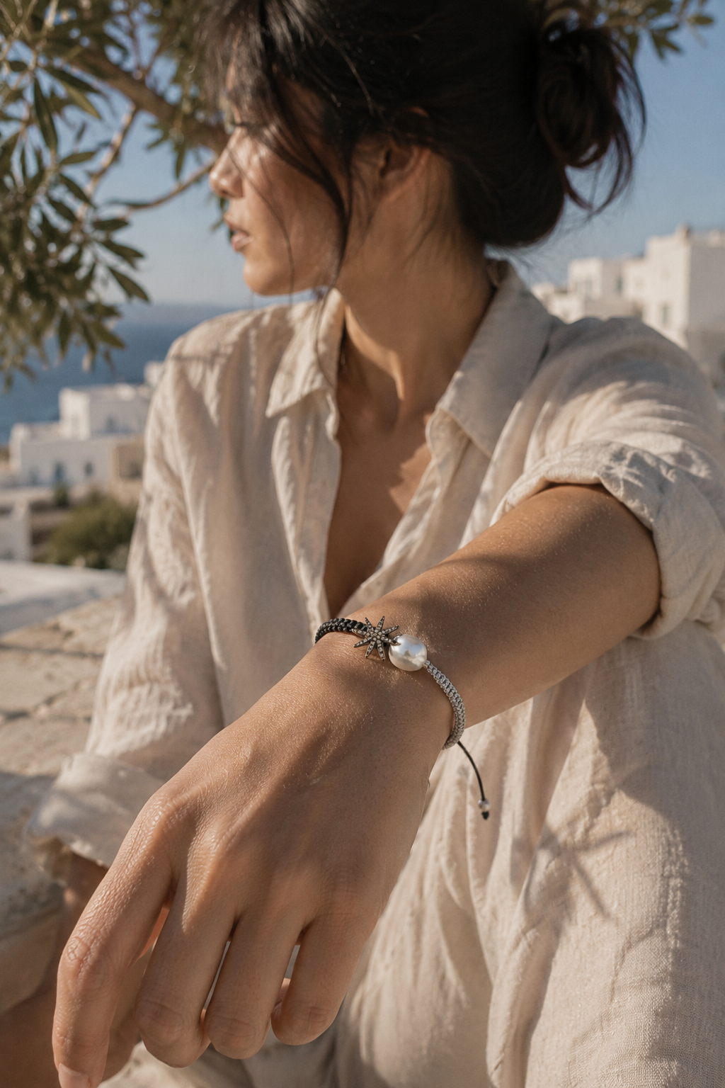 Stella macramé bracelet worn in Greece — champagne star, baroque pearl, natural Mediterranean light