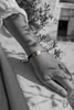 Stella macramé bracelet on wrist — oxidized silver star, baroque pearl, black and grey cord — black and white, Greece